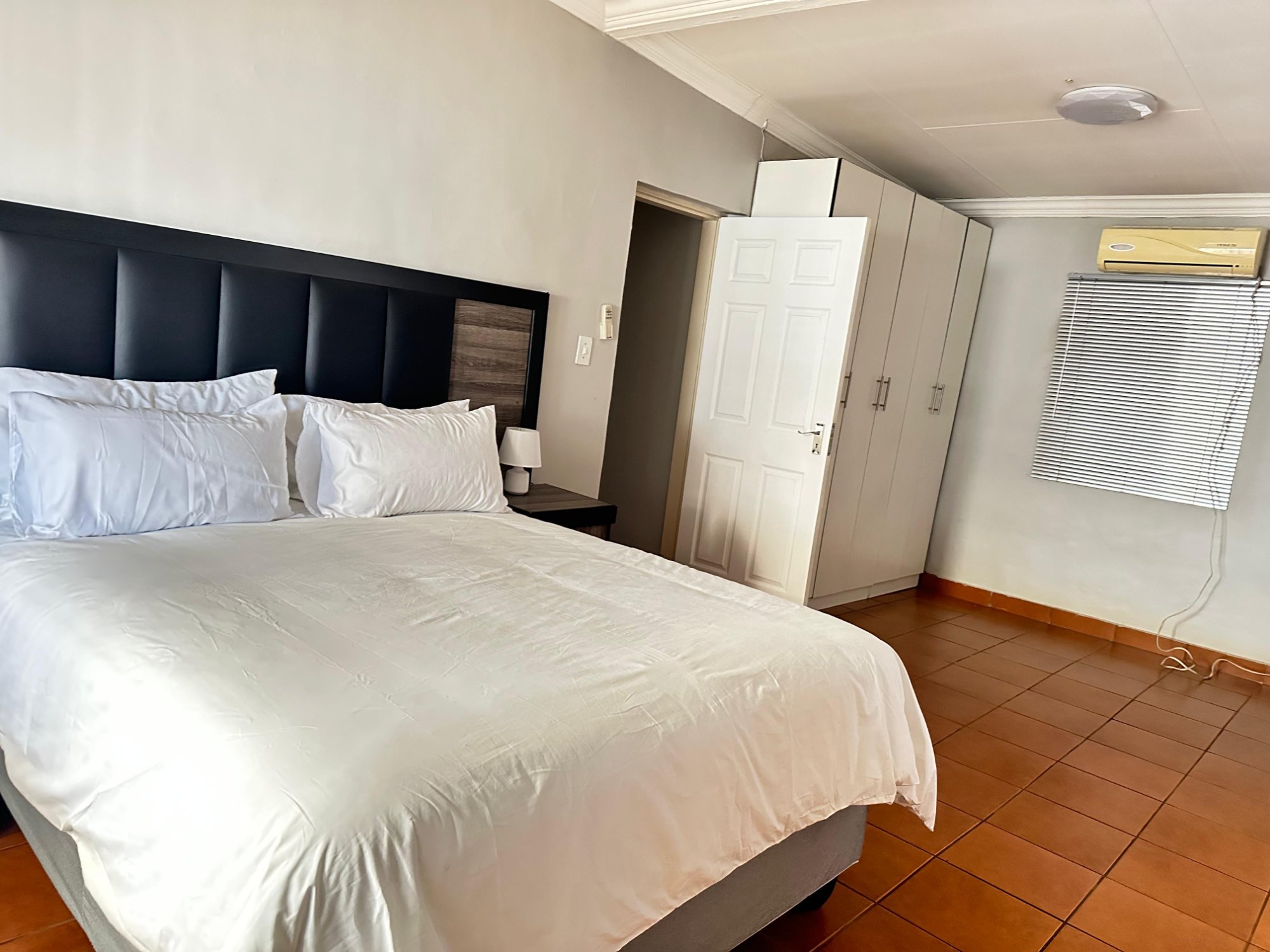 Master bedroom with queen bed and private en-suite bathroom at Dream and Drift Pretoria West